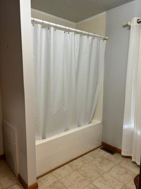 bathroom with shower / bathtub combination with curtain