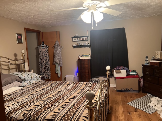 bedroom featuring ceiling fan, a textured ceiling, and light hardwood / wood-style flooring