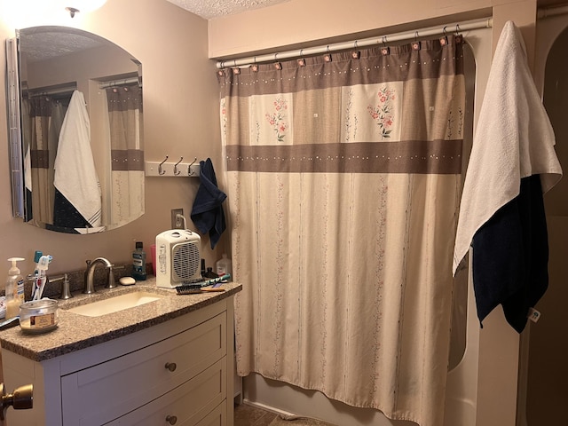 full bath featuring a textured ceiling and vanity