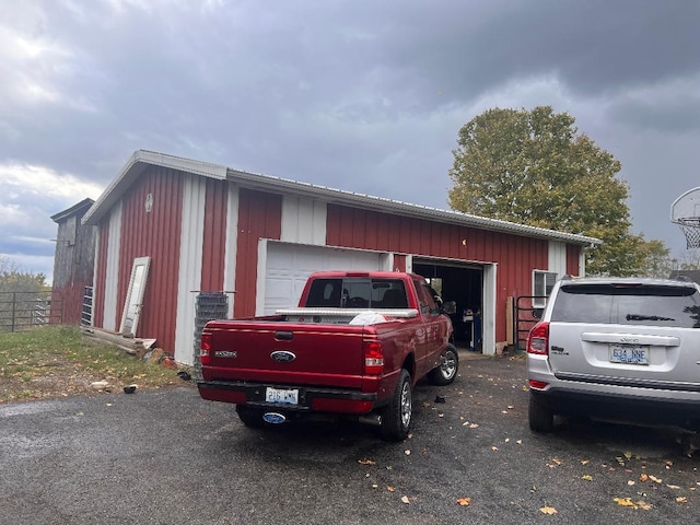 exterior space featuring a garage and an outdoor structure