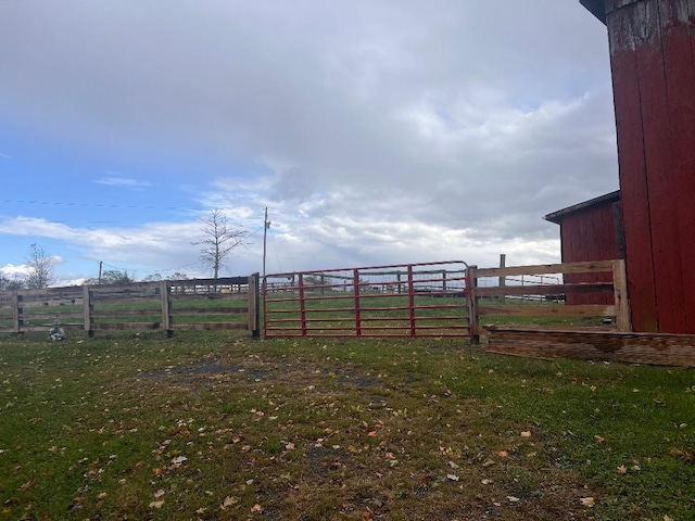 view of yard with a rural view and fence