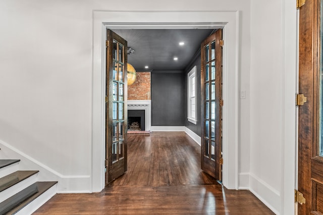 corridor with crown molding and dark hardwood / wood-style flooring