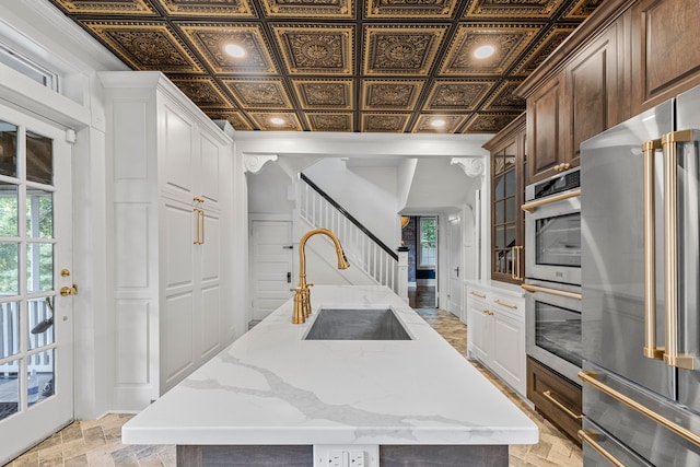 kitchen with sink, plenty of natural light, a center island, and stainless steel appliances