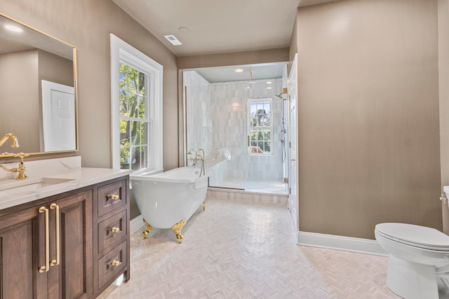 full bathroom featuring separate shower and tub, vanity, and toilet