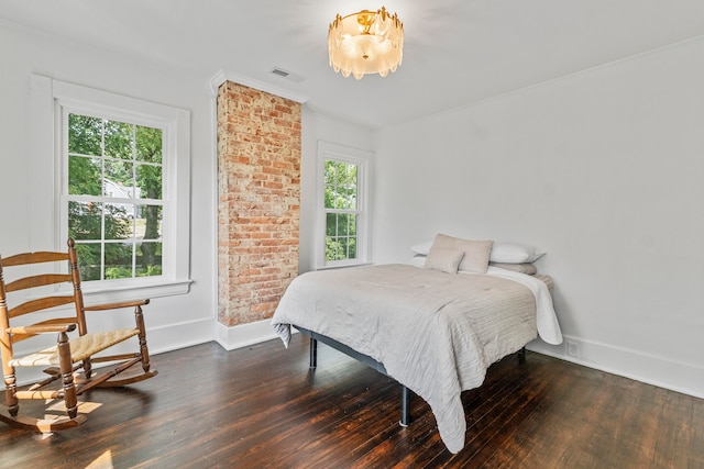 bedroom with dark wood-type flooring and multiple windows