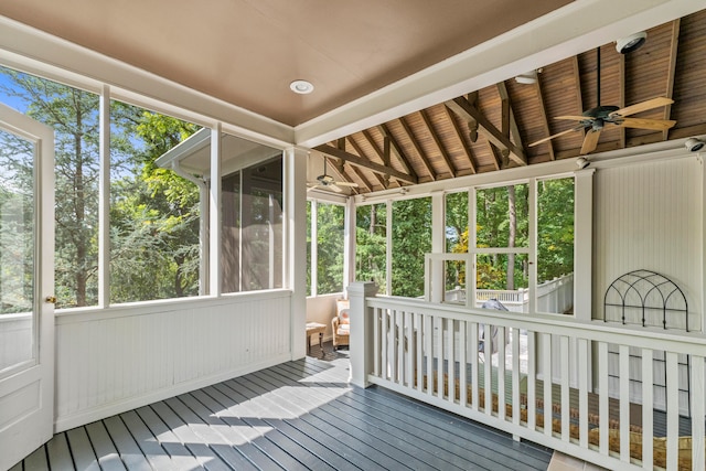 unfurnished sunroom with wood ceiling, lofted ceiling with beams, and ceiling fan