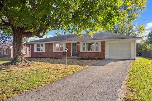 single story home with a front yard and a garage