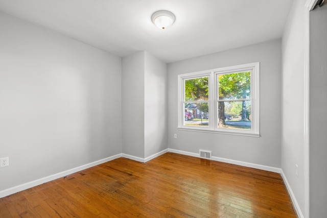 spare room with hardwood / wood-style floors