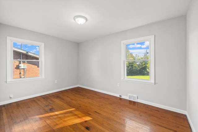 unfurnished room with wood-type flooring