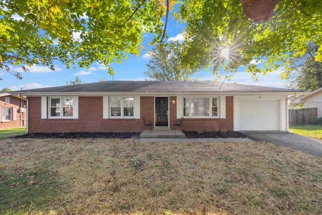 ranch-style house with a garage and a front yard