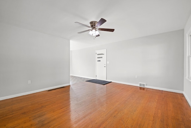 empty room featuring ceiling fan and hardwood / wood-style flooring