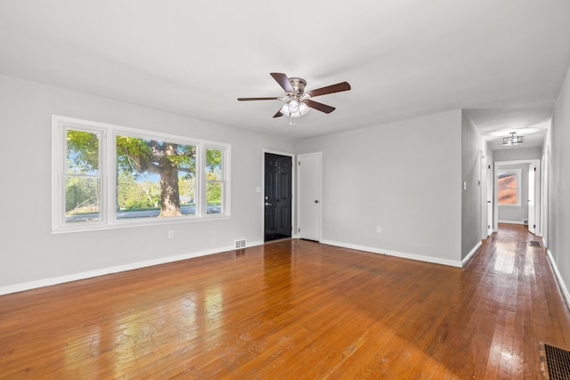 empty room featuring hardwood / wood-style flooring and ceiling fan