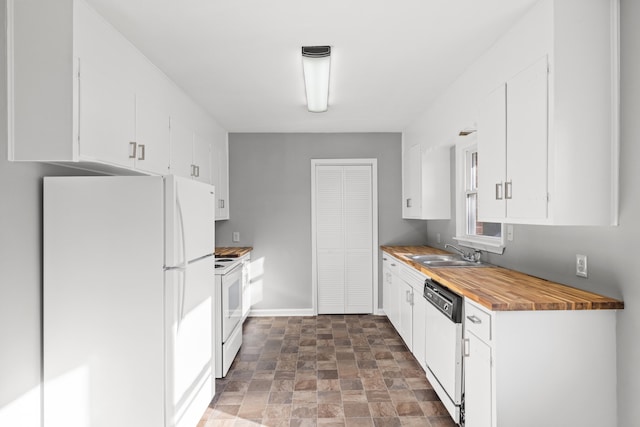 kitchen featuring wood counters, white appliances, sink, and white cabinetry