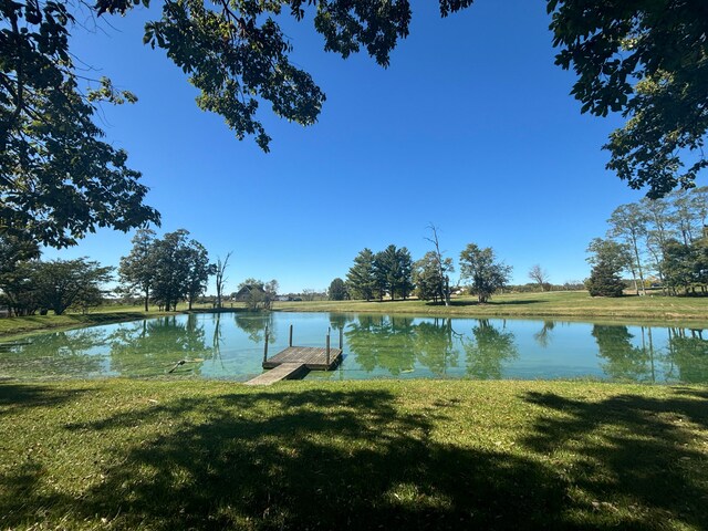 view of dock featuring a water view and a lawn