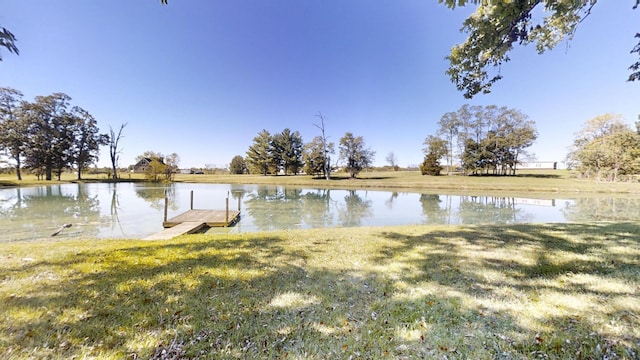 dock area with a water view and a lawn