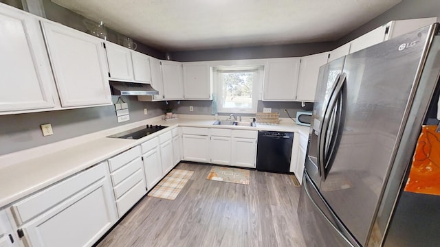 kitchen with white cabinetry, light hardwood / wood-style flooring, black appliances, and sink