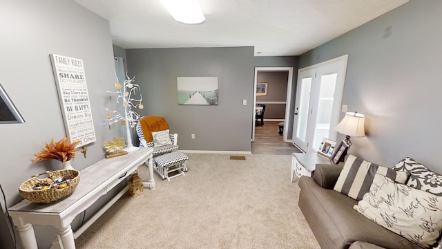 living area featuring light colored carpet