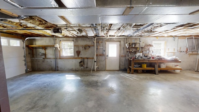 garage featuring a garage door opener and a workshop area