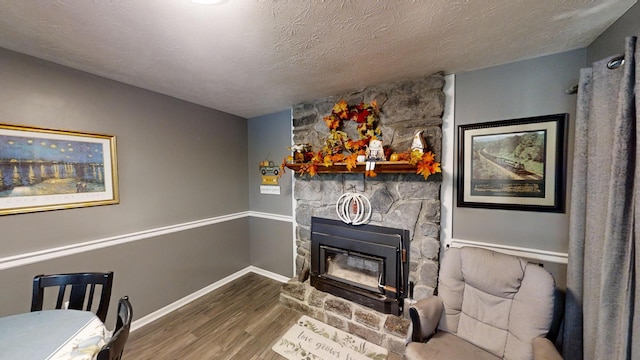 interior space with a textured ceiling, a fireplace, and hardwood / wood-style floors