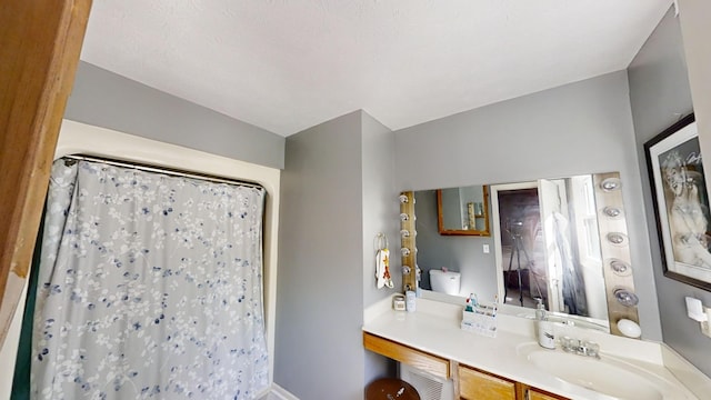 bathroom featuring vanity and curtained shower