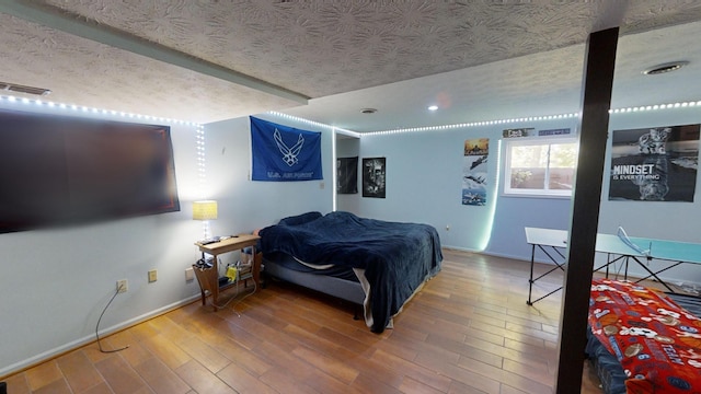 bedroom with hardwood / wood-style flooring