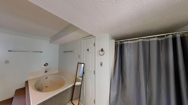 bathroom with a textured ceiling and separate shower and tub