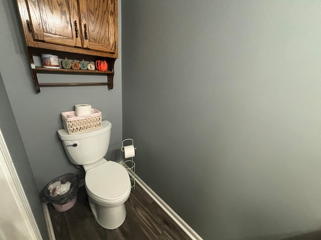 bathroom with toilet and hardwood / wood-style flooring