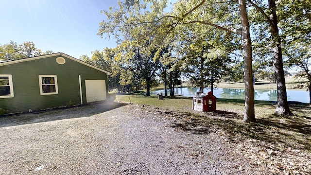 view of home's exterior with a garage and a water view