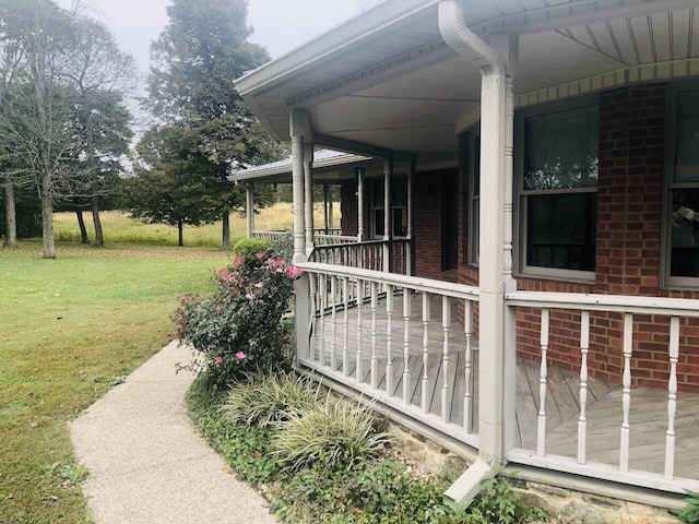 view of property exterior with a porch and a yard