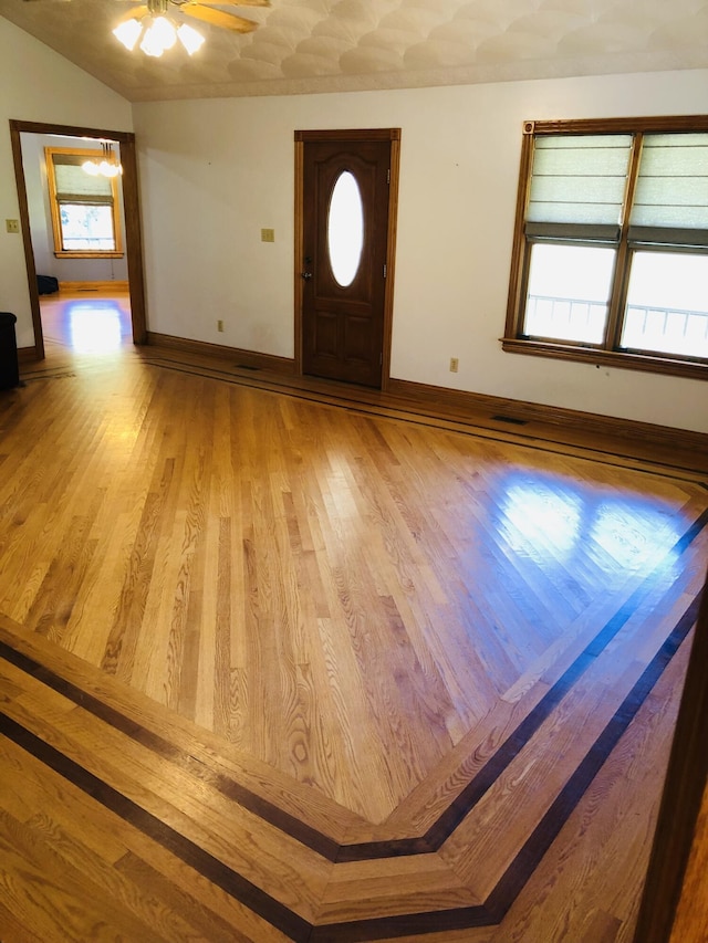 foyer with ceiling fan, light hardwood / wood-style flooring, and a wealth of natural light