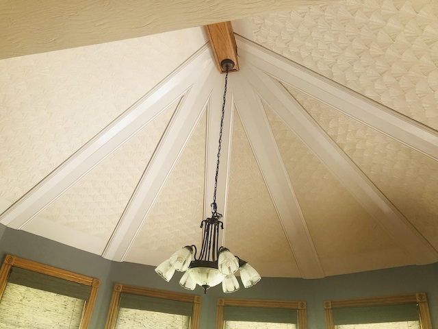 interior details featuring a chandelier and beam ceiling