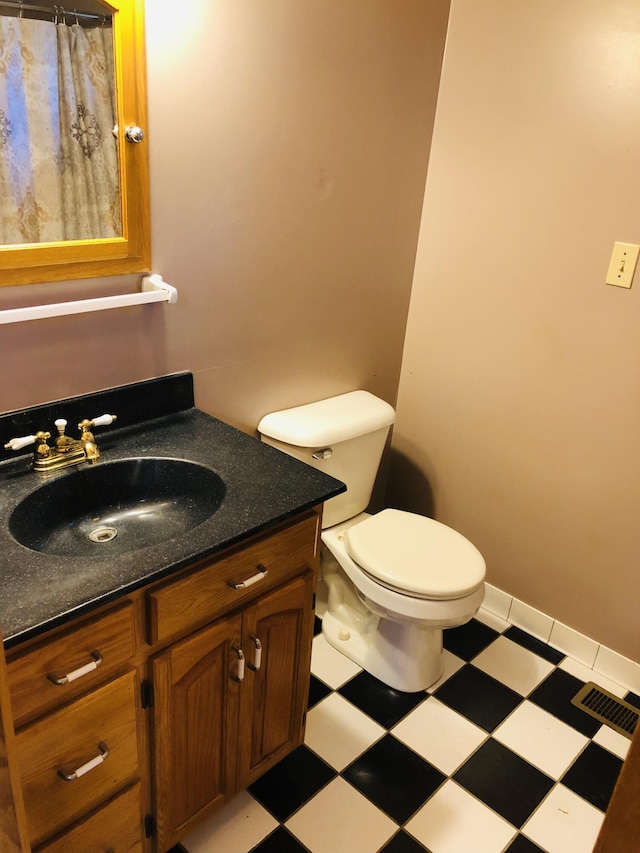 bathroom with vanity and toilet