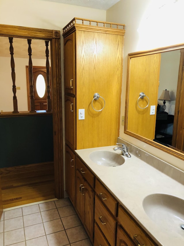 bathroom featuring tile patterned flooring and vanity