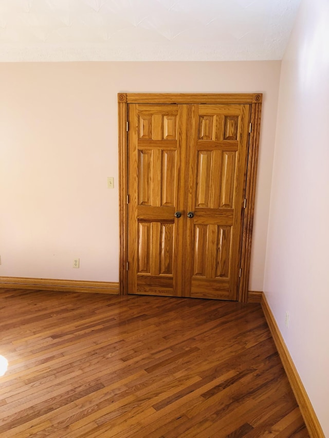 empty room featuring dark hardwood / wood-style flooring