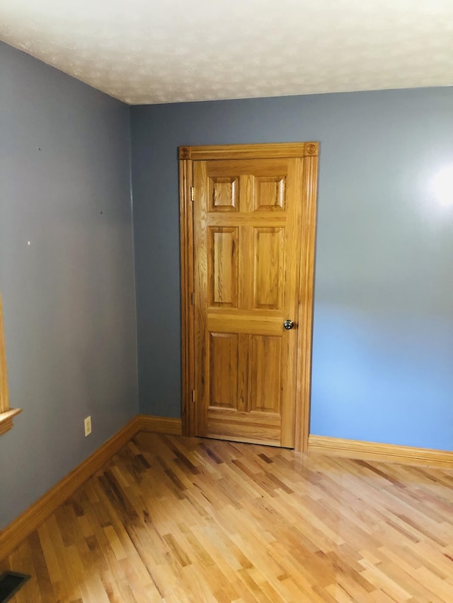 spare room featuring light hardwood / wood-style floors