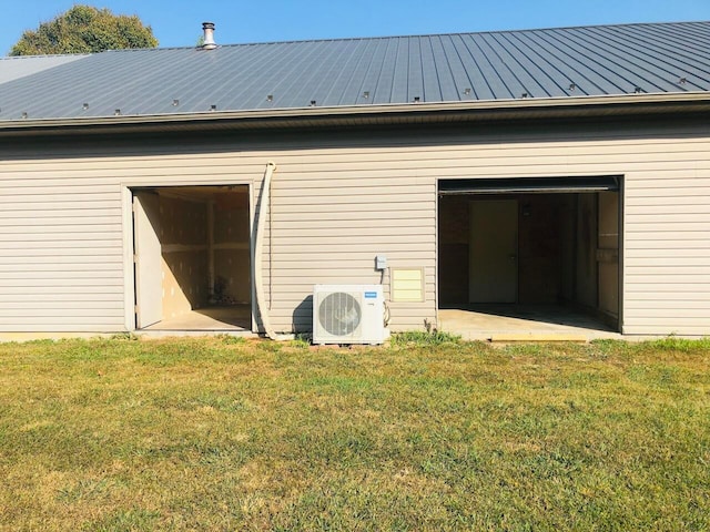 back of property with a yard and ac unit