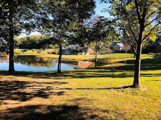 view of property's community featuring a water view and a lawn