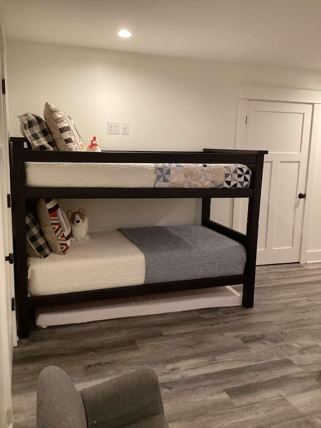 bedroom with dark wood-type flooring