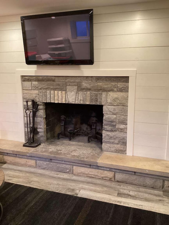 room details with hardwood / wood-style flooring and a fireplace