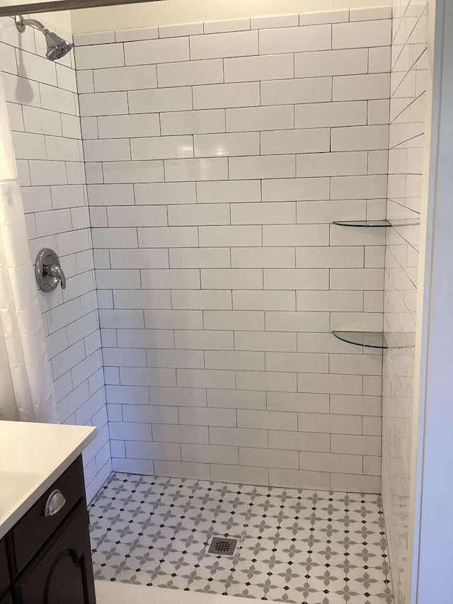 bathroom with curtained shower and vanity