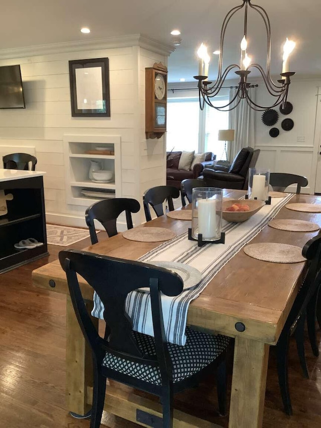 dining space with wood-type flooring and an inviting chandelier