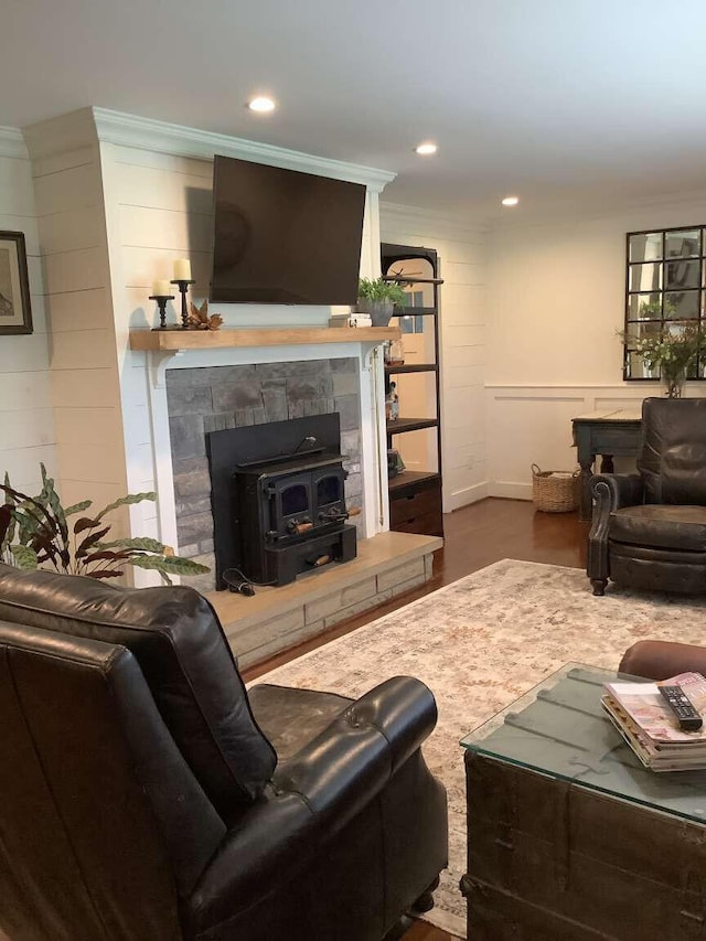 living room featuring ornamental molding and a wood stove