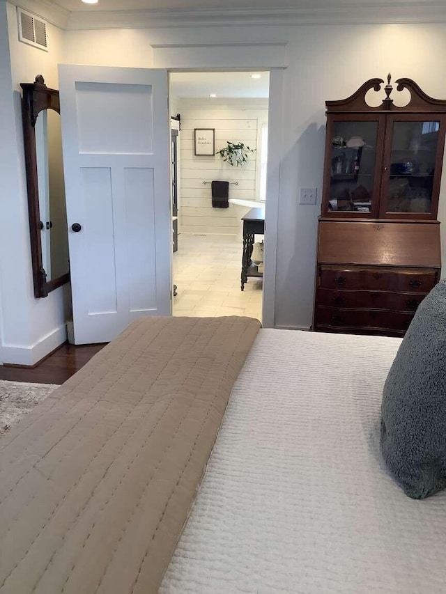 bedroom with wood-type flooring and wood walls