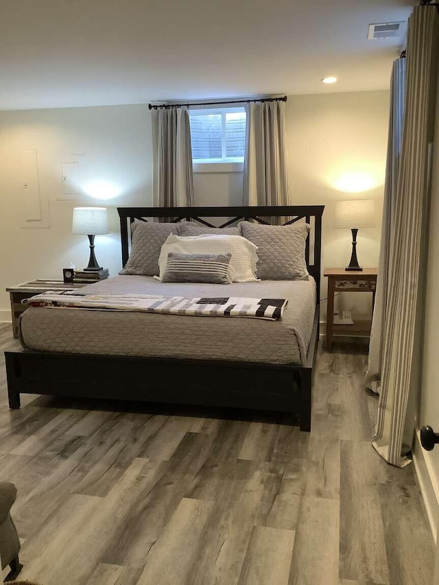 bedroom with hardwood / wood-style flooring