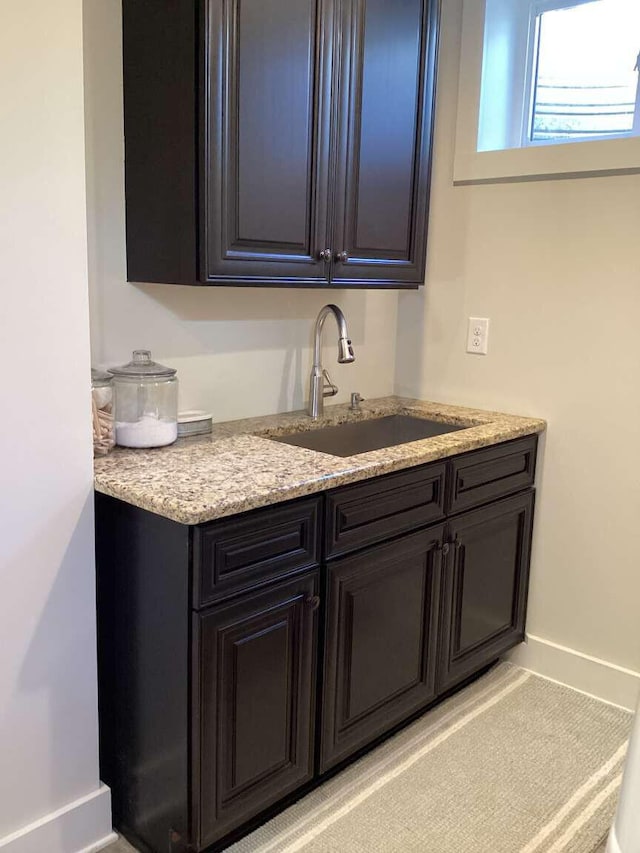 kitchen with sink and light stone counters