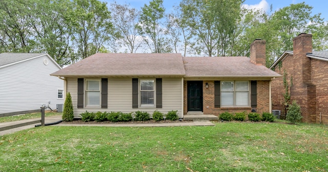 ranch-style home with a front lawn and central AC unit