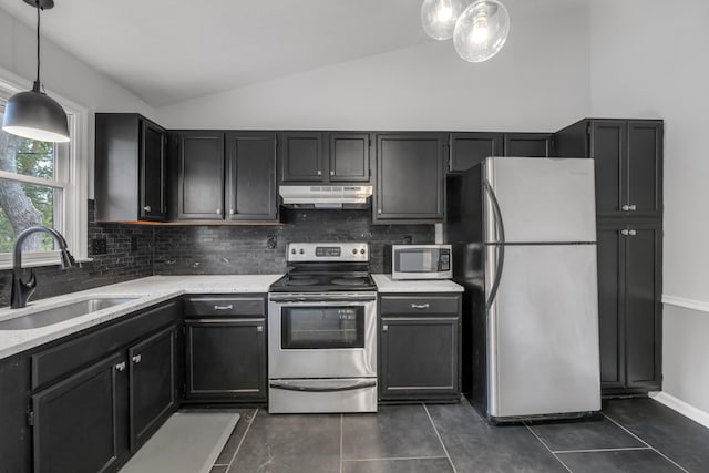 kitchen featuring stainless steel appliances, dark tile patterned flooring, sink, pendant lighting, and vaulted ceiling