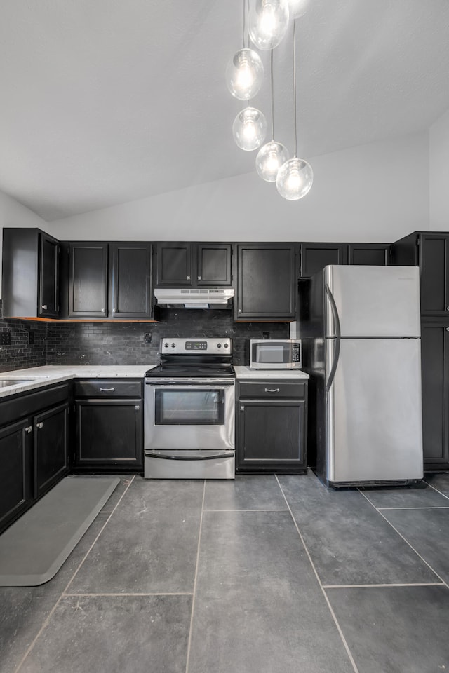 kitchen featuring backsplash, appliances with stainless steel finishes, hanging light fixtures, and vaulted ceiling