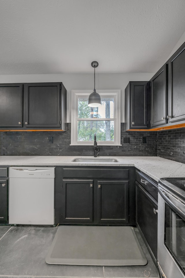 kitchen with pendant lighting, white dishwasher, sink, stainless steel electric stove, and decorative backsplash