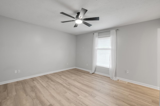 unfurnished room featuring ceiling fan, a textured ceiling, and light hardwood / wood-style flooring